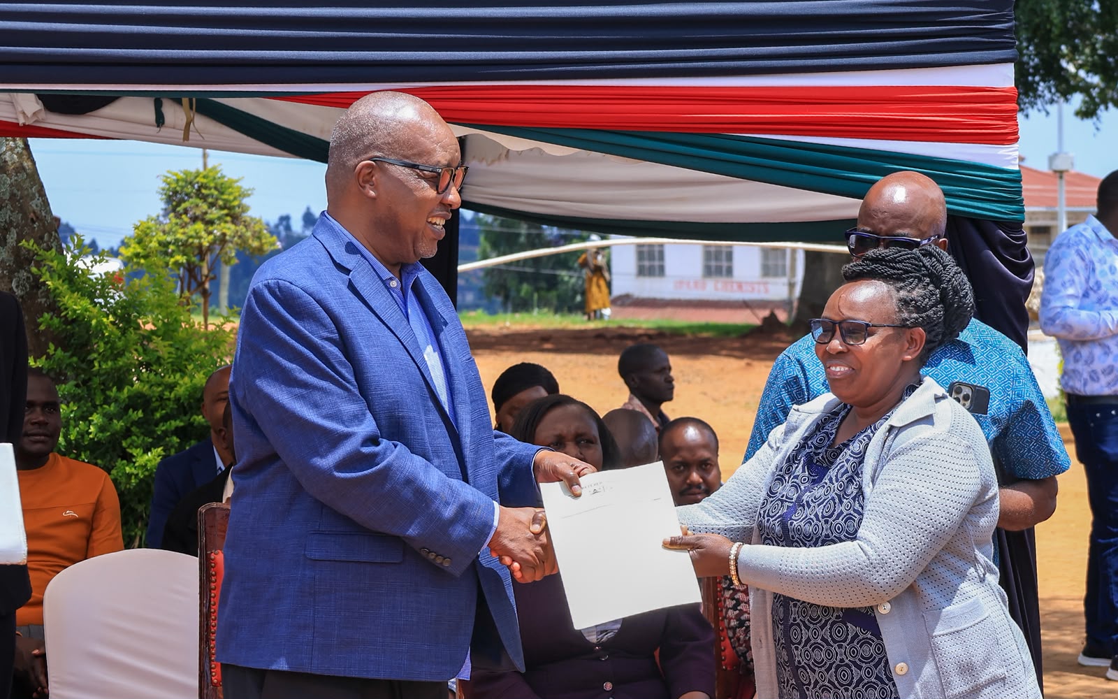 Governor Amos Nyaribo handing over employment letter to one of the officers on permanent and pensionable terms
