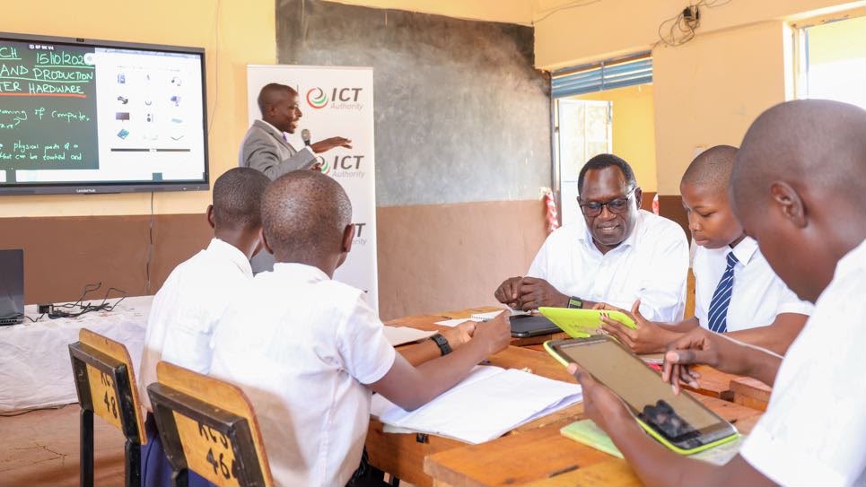 PS Stephen Isaboke engaging with Kisii Comprehensive School learners during the handover of smart boards and laptops.