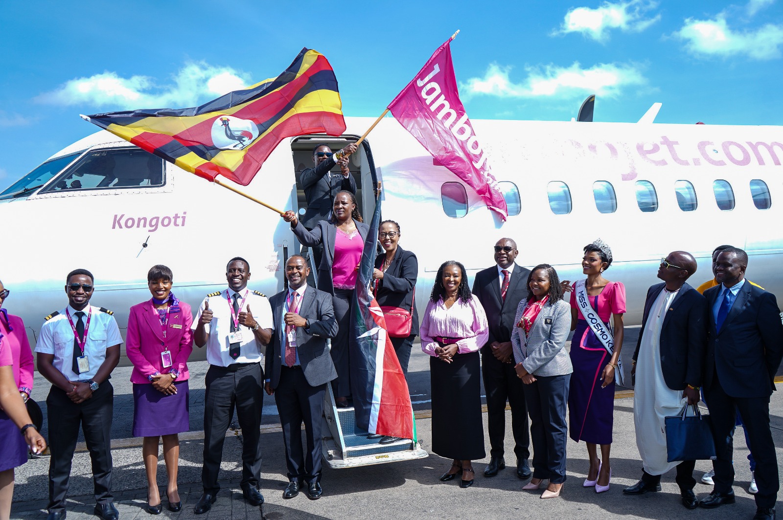 The Permanent Secretary, State Department for Aviation and Aerospace Development, Ms. Teresiah Mbaika (centre) leads Jambojet management and guests in celebrating the inaugural flight to Uganda.