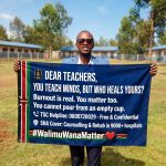 Wanjohi P. Mugambi holds a banner