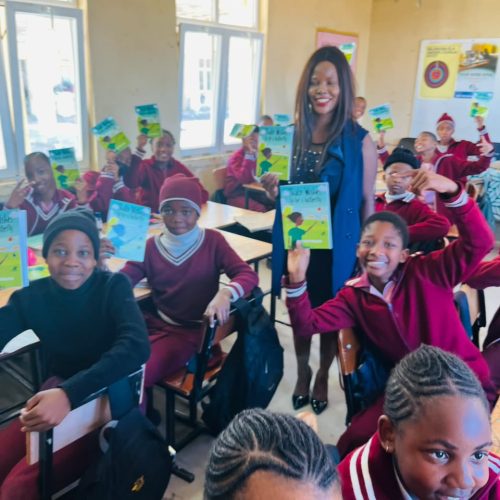 Dinokwane Primary in Serowe Mulher Forte African literature Outreach (First pioneering school 2026 book Donation) standing next to kids: Dr. Paula O.M.Otukile- founder Mulher Forte GBV- Powered by Unitarian International Funding Program