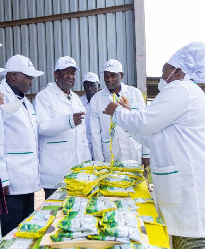 PCS Musalia Mudavadi being taken through some of the products at the tea factory.