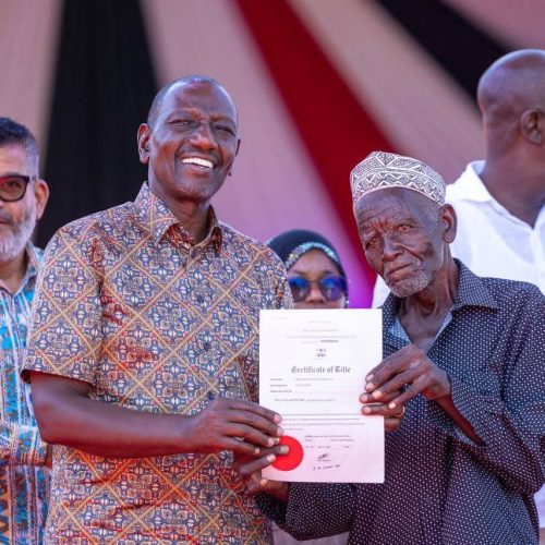President William Ruto presenting a Title Deed to one of the beneficiaries. Photos/Courtesy.